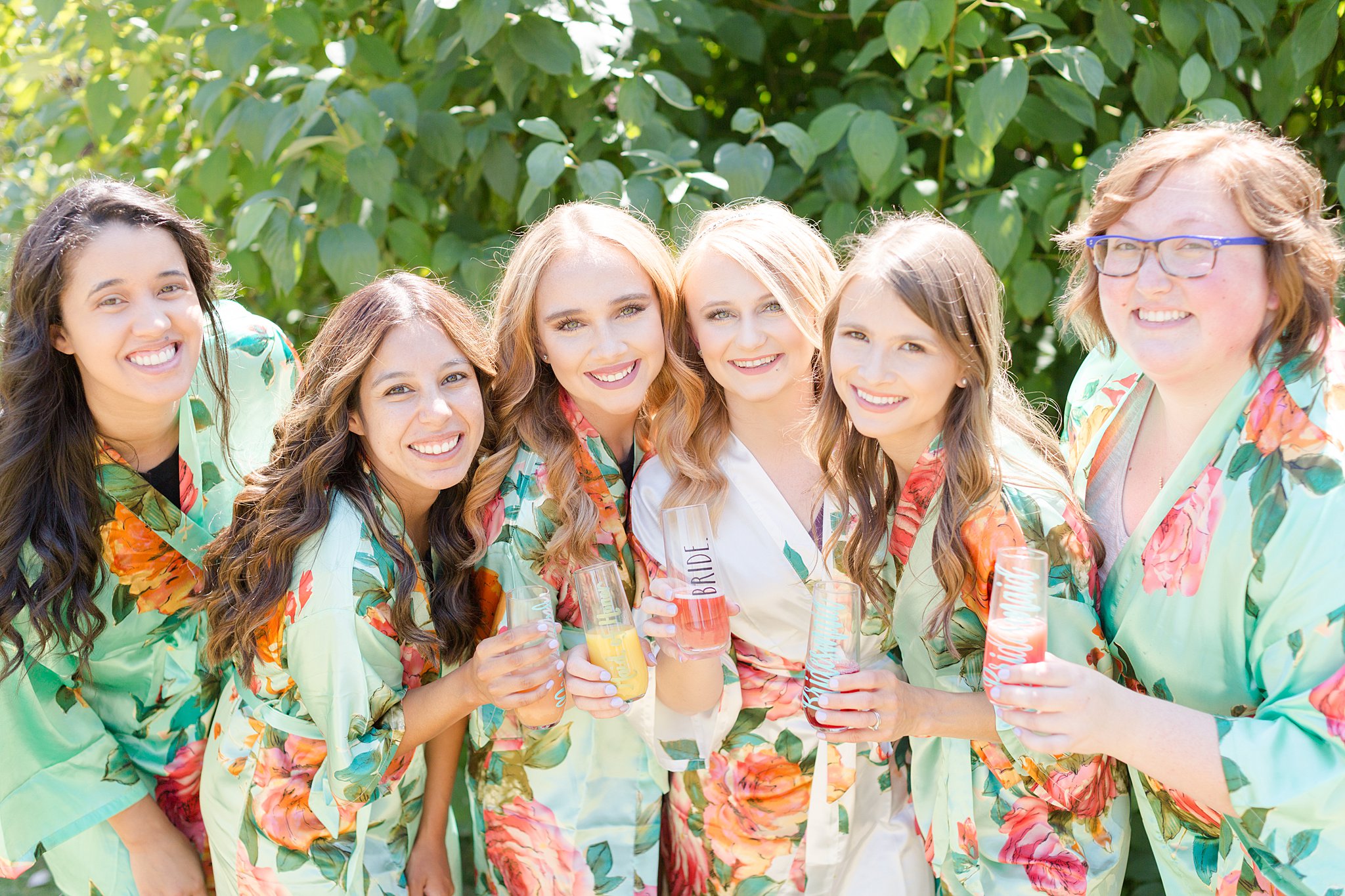 Bridesmaids giggling in matching robes